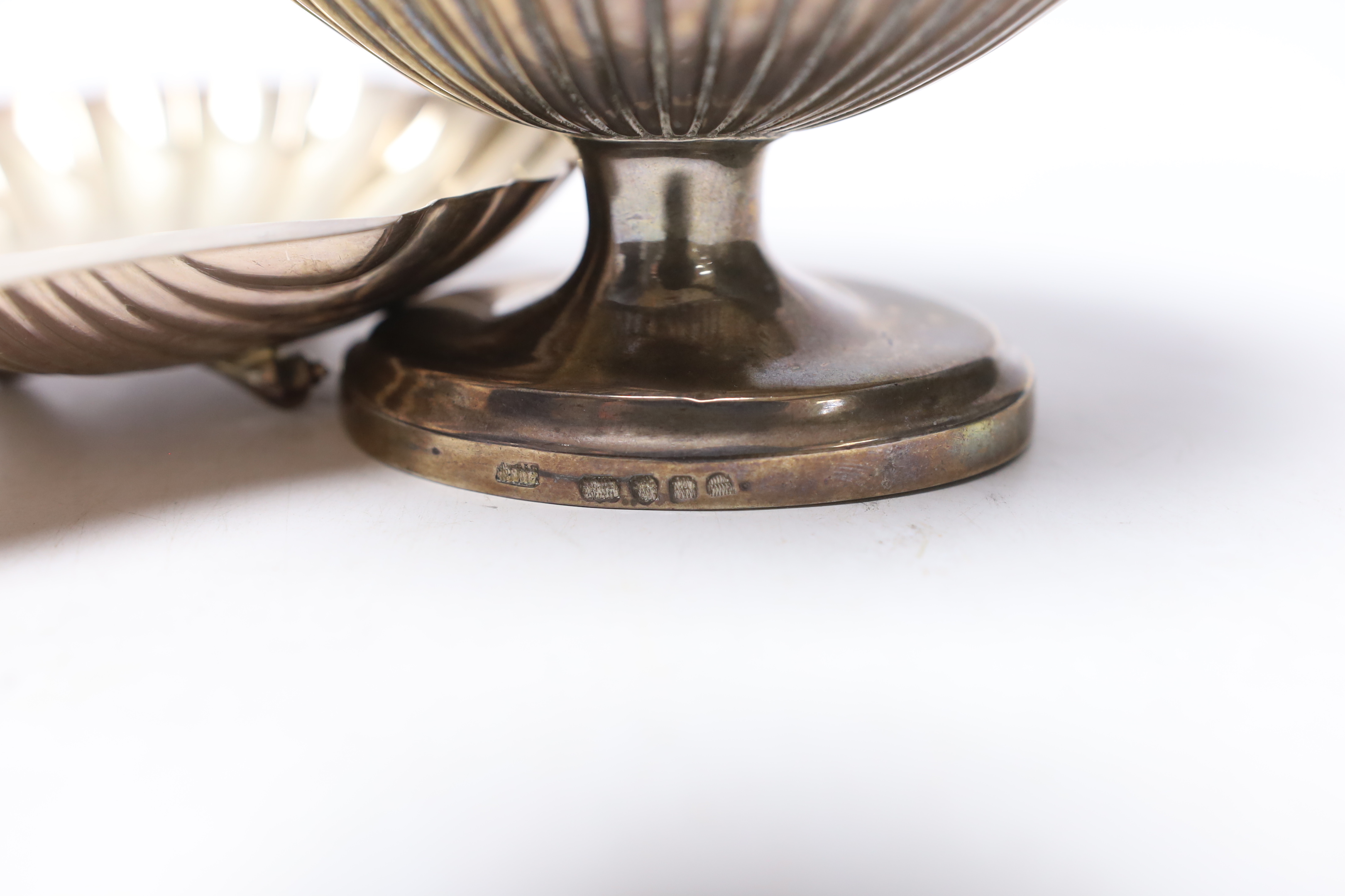 A modern silver sugar basket, London Assay Office marks for 1995 (cancelled earlier marks), an earlier silver butter shell and a sugar caster, 13.7oz.